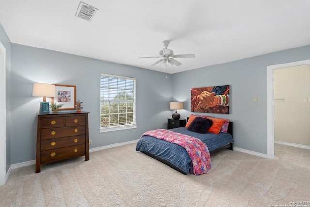 bedroom featuring light carpet, baseboards, and visible vents