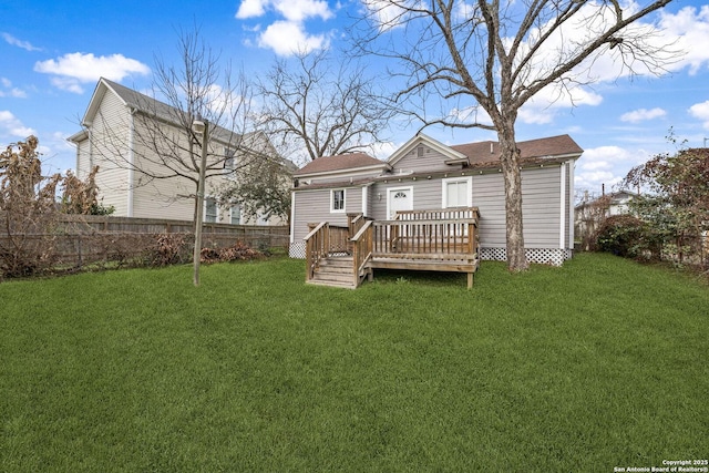 back of house featuring a yard, a deck, and fence