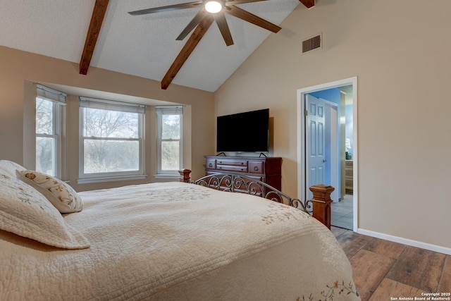 bedroom with visible vents, a ceiling fan, wood finished floors, beamed ceiling, and baseboards