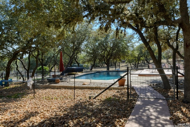 view of swimming pool featuring fence and a fenced in pool