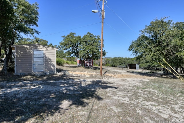 view of yard with an outbuilding and a shed