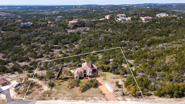 bird's eye view featuring a wooded view