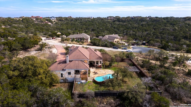 drone / aerial view with a wooded view