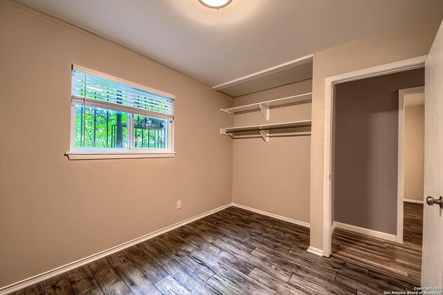 515 Park Mdw, San Antonio, TX 78227 - unfurnished bedroom featuring dark wood-style floors, a closet, and baseboards