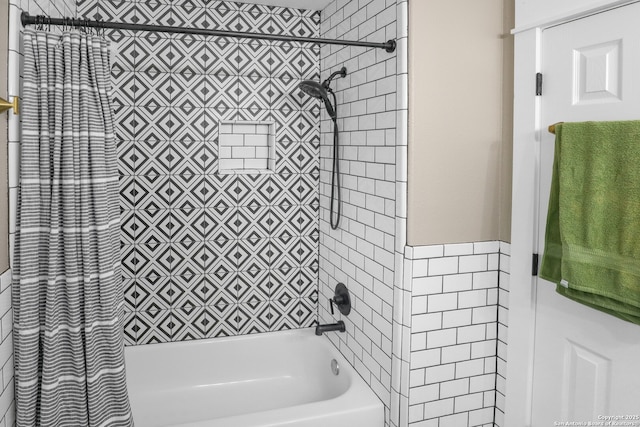 bathroom with shower / bathing tub combination and tile walls