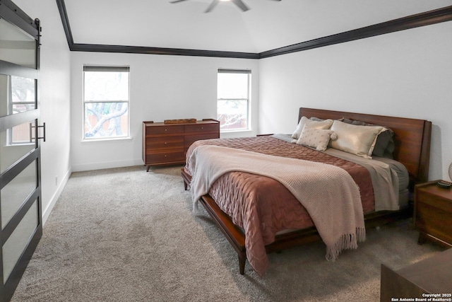 bedroom with light carpet, a barn door, ornamental molding, and baseboards