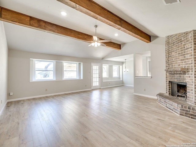 unfurnished living room featuring light wood finished floors, baseboards, a ceiling fan, vaulted ceiling with beams, and a brick fireplace