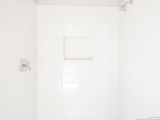 bathroom with tiled shower