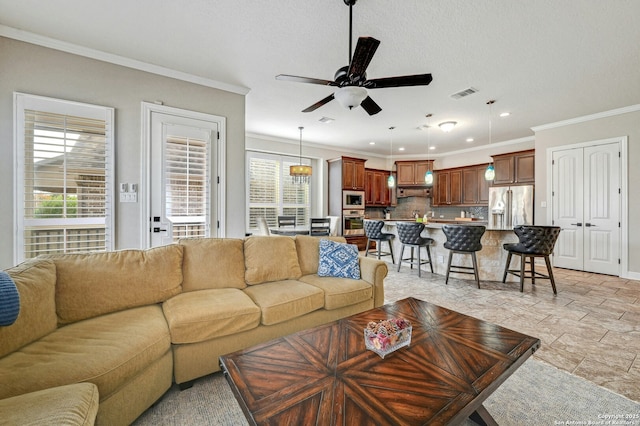 living room featuring crown molding, visible vents, a ceiling fan, and recessed lighting