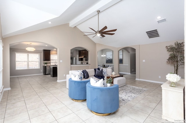 living area with arched walkways, light tile patterned floors, lofted ceiling with beams, and visible vents