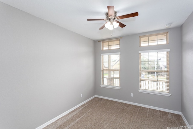 unfurnished room featuring carpet flooring, plenty of natural light, and baseboards