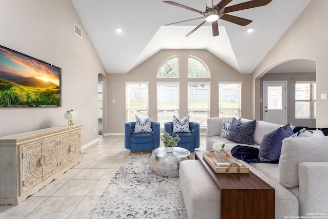 living room with light tile patterned floors, visible vents, arched walkways, and a ceiling fan