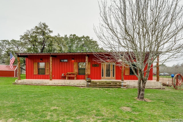 view of front facade featuring board and batten siding and a front yard