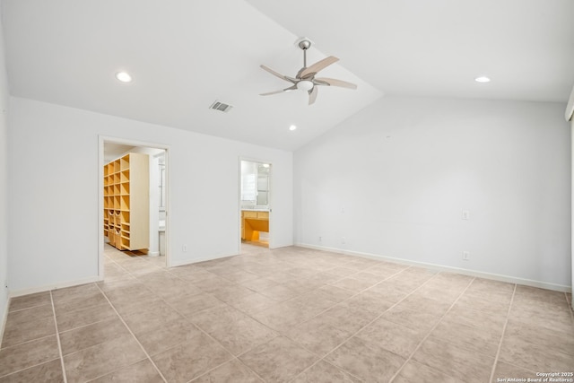 unfurnished room with baseboards, visible vents, vaulted ceiling, and a ceiling fan