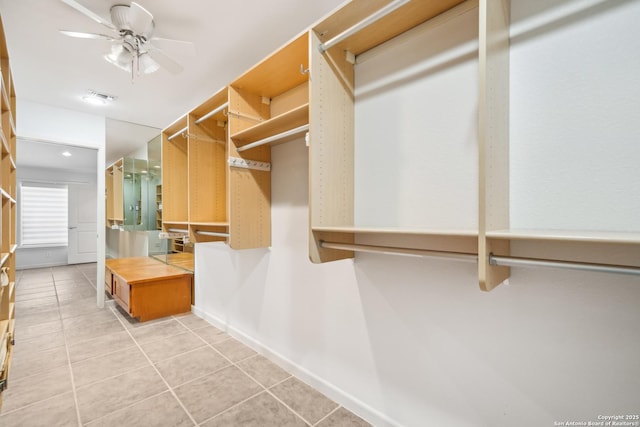 spacious closet featuring visible vents, ceiling fan, and light tile patterned floors