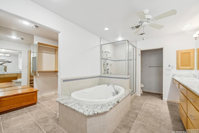 bathroom with a garden tub, toilet, visible vents, vanity, and a shower stall