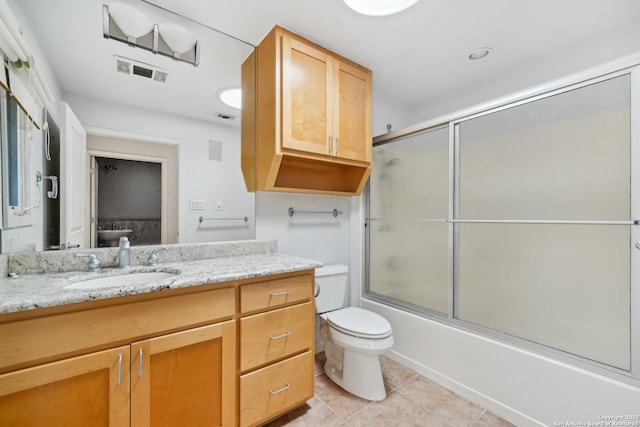 bathroom with visible vents, vanity, toilet, and tile patterned floors