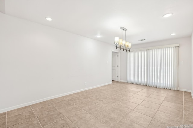 spare room with a chandelier, recessed lighting, visible vents, and baseboards