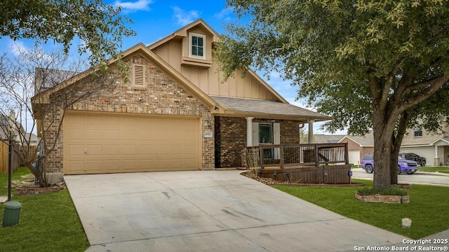 view of front of property featuring an attached garage, brick siding, driveway, a front lawn, and board and batten siding