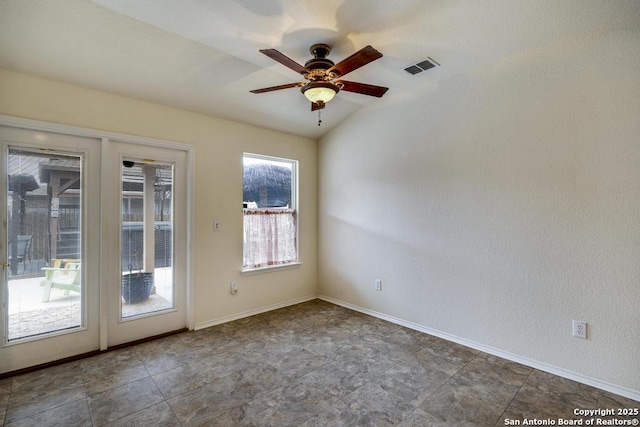 spare room featuring vaulted ceiling, ceiling fan, visible vents, and baseboards