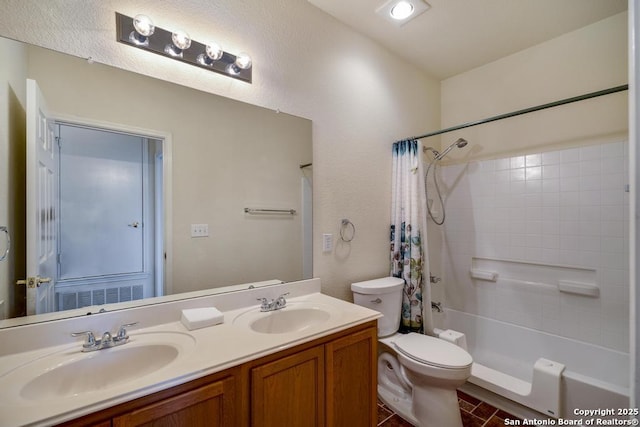 full bath with double vanity, shower / tub combo, a sink, and toilet