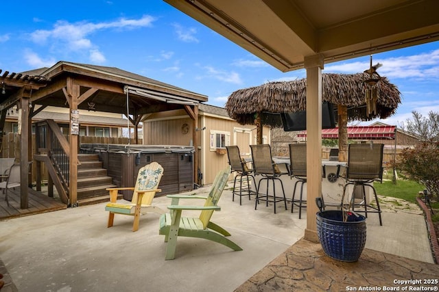 view of patio / terrace with outdoor dry bar and a hot tub