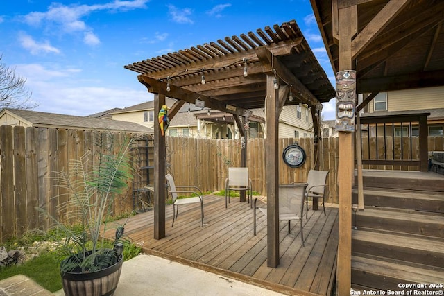 wooden deck featuring a fenced backyard and a pergola