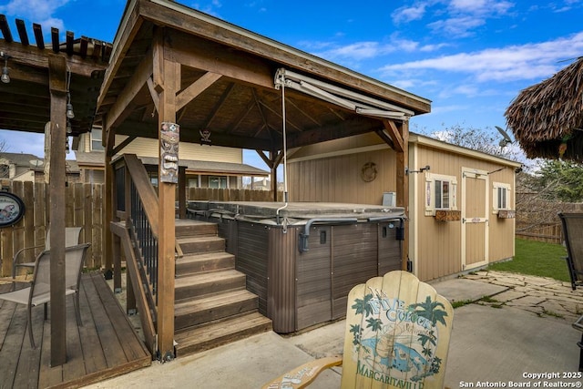 exterior space with a patio, fence, and a hot tub