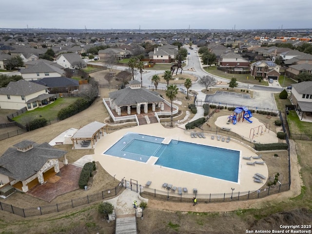 view of swimming pool featuring an enclosed area and a residential view