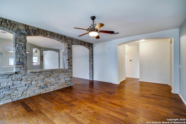 unfurnished room featuring ceiling fan, visible vents, and wood finished floors