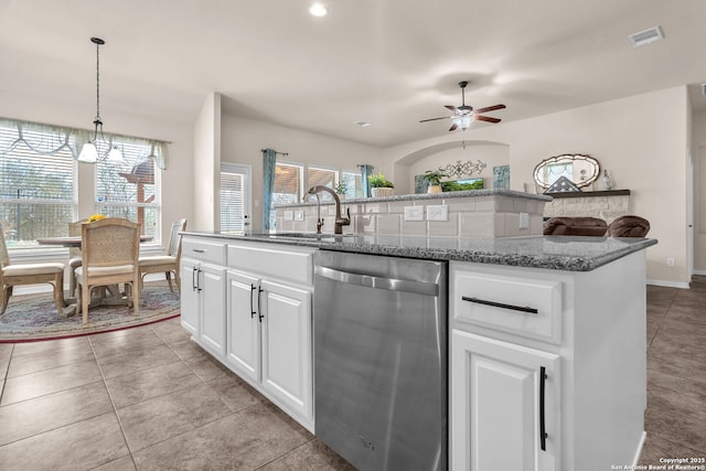 kitchen featuring white cabinets, dishwasher, an island with sink, pendant lighting, and a sink