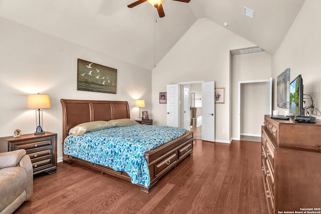 bedroom with high vaulted ceiling, dark wood-type flooring, visible vents, and baseboards