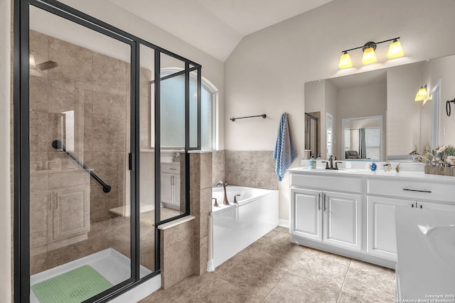 bathroom with vanity, vaulted ceiling, a bath, tile patterned floors, and a stall shower