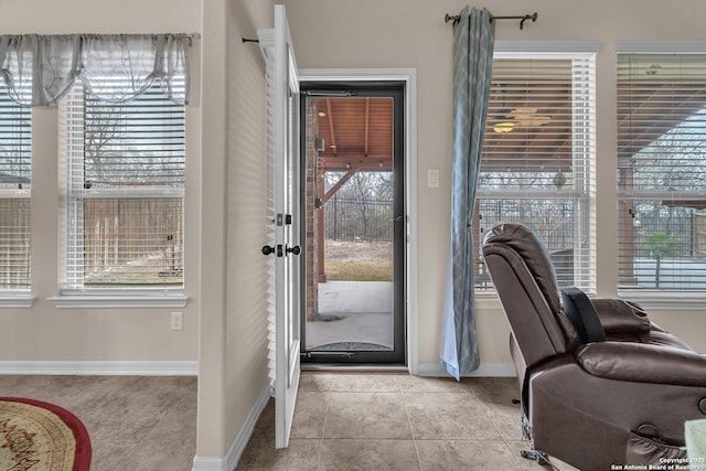 entryway with light tile patterned floors and baseboards