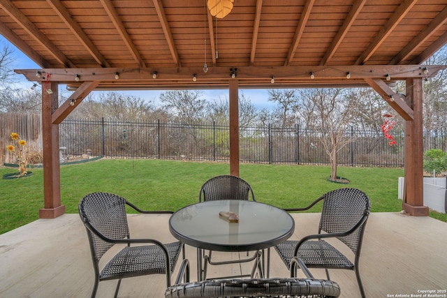 view of patio featuring fence and outdoor dining space