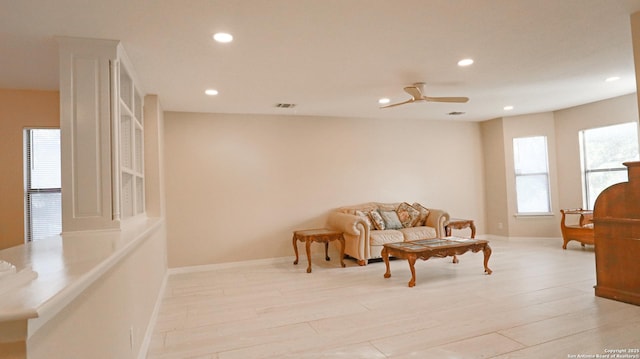 living room with light wood-style flooring, recessed lighting, a ceiling fan, baseboards, and visible vents