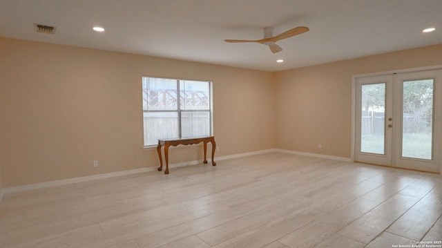 spare room featuring light wood-style floors, recessed lighting, and visible vents