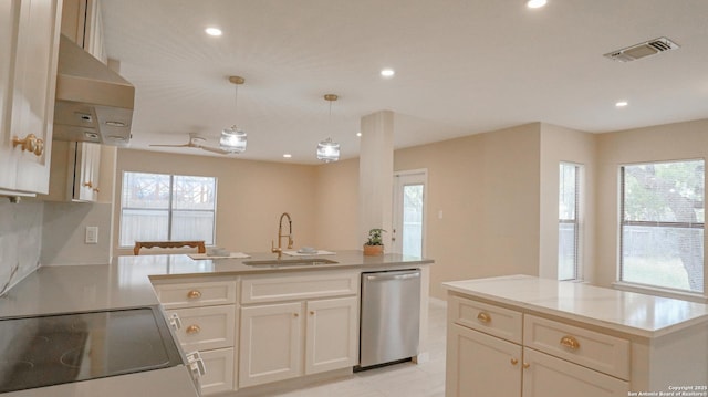 kitchen featuring visible vents, an island with sink, appliances with stainless steel finishes, hanging light fixtures, and a sink