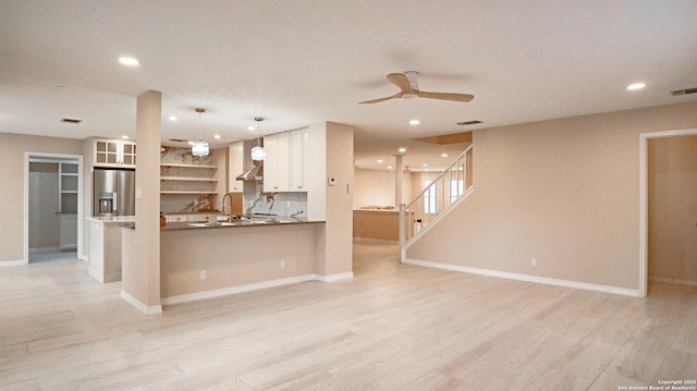 unfurnished living room with baseboards, a ceiling fan, stairs, light wood-style floors, and recessed lighting