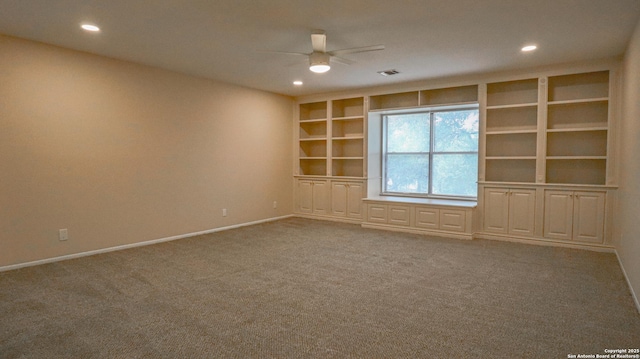 carpeted empty room featuring visible vents, baseboards, ceiling fan, built in shelves, and recessed lighting