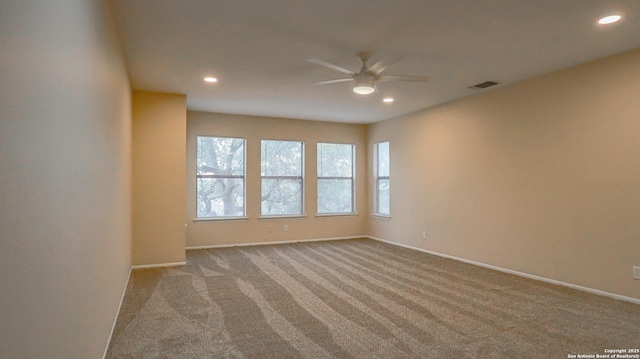 spare room with baseboards, light colored carpet, a ceiling fan, and recessed lighting