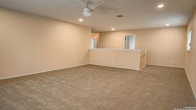 carpeted empty room featuring baseboards, visible vents, ceiling fan, and recessed lighting