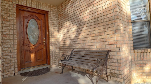 entrance to property with brick siding