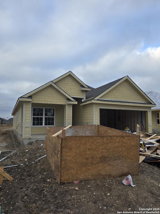 unfinished property featuring an attached garage