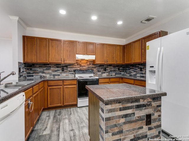 kitchen with visible vents, ornamental molding, a sink, white appliances, and under cabinet range hood