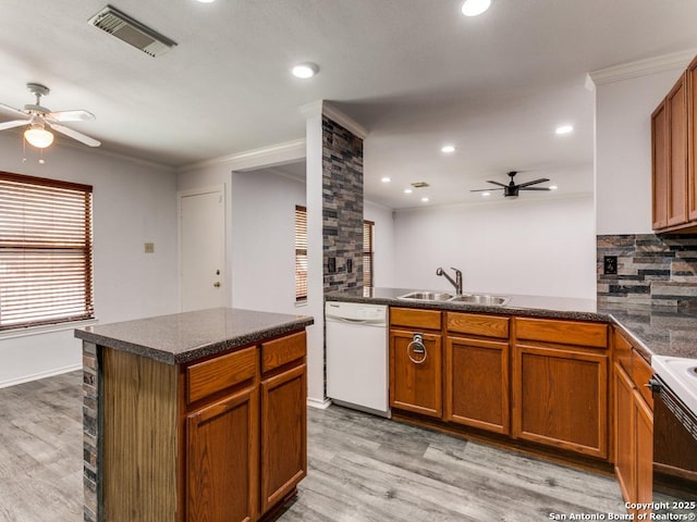 kitchen featuring white appliances, visible vents, a ceiling fan, dark countertops, and a sink