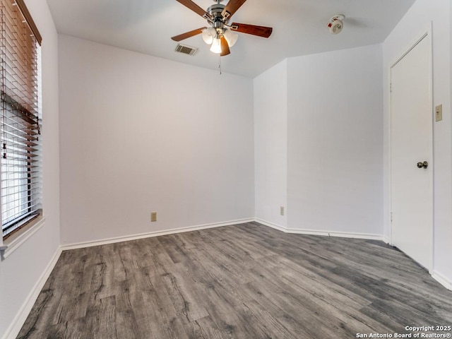 unfurnished bedroom featuring baseboards, visible vents, ceiling fan, and wood finished floors