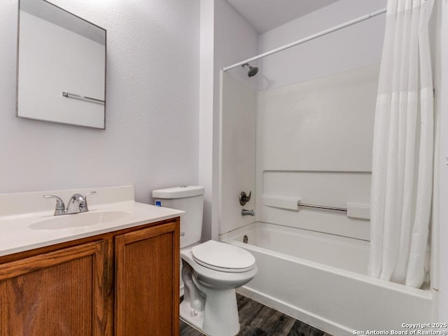 full bathroom featuring vanity, wood finished floors, shower / bath combination with curtain, and toilet