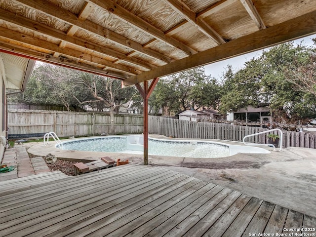 view of swimming pool featuring a fenced in pool, a fenced backyard, a patio, and a deck