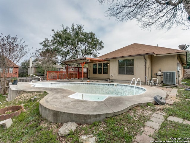 view of swimming pool with fence, central AC unit, a fenced in pool, and a wooden deck